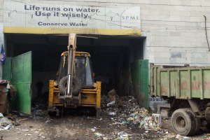 A dredger moves trash in a dump